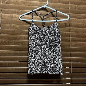 Lululemon tank top with black under bra, with white spots as the design